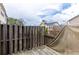 View of a wooden back deck with a tan cover and wooden fencing at 1212 Lake Point Way, Suwanee, GA 30024