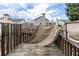 View of a wooden back deck with a tan cover and a view of the community at 1212 Lake Point Way, Suwanee, GA 30024