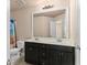 Full bathroom with double sinks, white countertops and dark cabinets at 1212 Lake Point Way, Suwanee, GA 30024