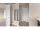 Bathroom featuring tile flooring, glass shower, and entry to the bedroom at 1212 Lake Point Way, Suwanee, GA 30024