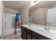 Full bathroom with double sinks, white countertops and dark cabinets at 1212 Lake Point Way, Suwanee, GA 30024