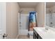 Full bathroom with double sinks, white countertops and dark cabinets at 1212 Lake Point Way, Suwanee, GA 30024
