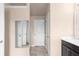 Bathroom view with large mirror and vanity with doors leading to additional rooms at 1212 Lake Point Way, Suwanee, GA 30024