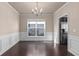 Dining room featuring hardwood floors, wainscotting and modern chandelier at 1212 Lake Point Way, Suwanee, GA 30024
