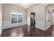 Bright dining room features hardwood floors, a chandelier, large window, and classic chair rail molding at 1212 Lake Point Way, Suwanee, GA 30024