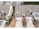 Aerial view of townhomes with two-car garages and landscaped yards at 1212 Lake Point Way, Suwanee, GA 30024