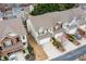 Aerial view of townhomes with two-car garages and well maintained landscaping at 1212 Lake Point Way, Suwanee, GA 30024