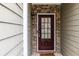 Close-up of a welcoming front door with sidelights and brick surround at 1212 Lake Point Way, Suwanee, GA 30024