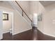 Hardwood hallway with staircase and access to powder room and backyard at 1212 Lake Point Way, Suwanee, GA 30024