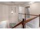 View of the home's hallway with detailed trim, and hanging ornate lighting fixture at 1212 Lake Point Way, Suwanee, GA 30024