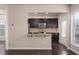 Modern kitchen with dark wood cabinets, granite countertops, stainless steel appliances, and a breakfast bar at 1212 Lake Point Way, Suwanee, GA 30024