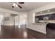 Open living area with hardwood floors, kitchen access, and a dining room with elegant wainscoting at 1212 Lake Point Way, Suwanee, GA 30024