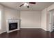 Inviting living room featuring a fireplace, ceiling fan, hardwood floors, and neutral paint at 1212 Lake Point Way, Suwanee, GA 30024
