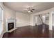 Open concept living room featuring a fireplace, hardwood floors, a staircase, and neutral paint at 1212 Lake Point Way, Suwanee, GA 30024