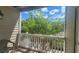 Cozy balcony with white railing overlooks lush greenery under a bright, blue sky at 1250 Parkwood Cir # 2112, Atlanta, GA 30339