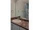 A bathroom featuring a large mirror, countertop with a sink, and a towel rack at 1250 Parkwood Cir # 2112, Atlanta, GA 30339