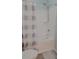 Bathroom features a shower with bathtub and a white and gray shower curtain, providing a relaxing space at 1250 Parkwood Cir # 2112, Atlanta, GA 30339