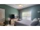Cozy bedroom with a bed, TV, dresser, and neutral-colored walls with natural light from the window at 1250 Parkwood Cir # 2112, Atlanta, GA 30339