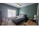 A cozy bedroom featuring a bed, desk, ceiling fan, and neutral-colored walls with natural light from the window at 1250 Parkwood Cir # 2112, Atlanta, GA 30339