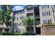Exterior view of a three-story apartment building with balconies and black shuttered windows at 1250 Parkwood Cir # 2112, Atlanta, GA 30339