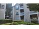 Exterior view of a tan apartment building with white balconies and black shutters at 1250 Parkwood Cir # 2112, Atlanta, GA 30339