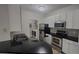 Contemporary kitchen featuring sleek countertops, white cabinetry, and stainless steel appliances at 1250 Parkwood Cir # 2112, Atlanta, GA 30339