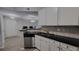 Kitchen with stainless appliances and breakfast bar, open to a living area with natural light at 1250 Parkwood Cir # 2112, Atlanta, GA 30339