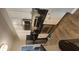Kitchen with stainless steel appliances, white cabinets, black countertops, and gray laminate flooring throughout at 1250 Parkwood Cir # 2112, Atlanta, GA 30339