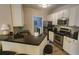 Modern kitchen with stainless steel appliances, dark countertops, and ample cabinet space at 1250 Parkwood Cir # 2112, Atlanta, GA 30339