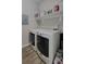 A laundry room with a washer, dryer, shelving, and gray walls at 1250 Parkwood Cir # 2112, Atlanta, GA 30339