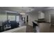 Open-concept living room with kitchen bar, with neutral colors and plenty of natural light at 1250 Parkwood Cir # 2112, Atlanta, GA 30339