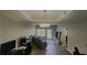 Bright living room with a tray ceiling, a ceiling fan, a TV, and a comfortable seating area at 1250 Parkwood Cir # 2112, Atlanta, GA 30339