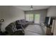 Cozy living room featuring a ceiling fan, plush seating, and natural light from the door and window at 1250 Parkwood Cir # 2112, Atlanta, GA 30339