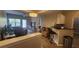 Open concept living space with hardwood floors and modern lighting, leading to a bright balcony at 1250 Parkwood Cir # 2112, Atlanta, GA 30339