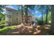Back yard area with porch swing and two chairs, shaded by trees at 1250 Parkwood Cir # 2112, Atlanta, GA 30339
