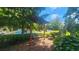 Landscaped common outdoor area with pergola and path through leafy green bushes at 1250 Parkwood Cir # 2112, Atlanta, GA 30339