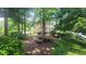 Community picnic area featuring grills and a table, surrounded by trees and greenery at 1250 Parkwood Cir # 2112, Atlanta, GA 30339
