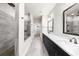 Modern bathroom featuring a walk-in shower, double vanity, and a sleek, contemporary design with grey tile at 219 Phillips Ln, Alpharetta, GA 30009