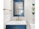 Stylish bathroom with a blue vanity, marble countertop, and gold fixtures at 219 Phillips Ln, Alpharetta, GA 30009