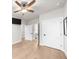 A bedroom with white doors, light-colored hardwood flooring, and a ceiling fan at 219 Phillips Ln, Alpharetta, GA 30009