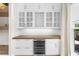 Dining area featuring custom built-in wine storage with glass doors at 219 Phillips Ln, Alpharetta, GA 30009