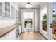 Dining room with built-in cabinets, wine cooler, and abundant natural light at 219 Phillips Ln, Alpharetta, GA 30009
