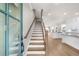 Elegant entryway with wood staircase, light hardwood floors, and an open layout leading to a modern kitchen at 219 Phillips Ln, Alpharetta, GA 30009