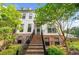 Inviting two-story townhome boasts classic architectural design with brick accents, an inviting staircase, and lush landscaping at 219 Phillips Ln, Alpharetta, GA 30009