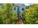 Charming white townhouse with well-manicured landscaping and a welcoming brick staircase leading to the front door at 219 Phillips Ln, Alpharetta, GA 30009