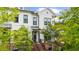 Charming two-story townhome with a brick-accented facade, an inviting staircase, and well-manicured landscaping at 219 Phillips Ln, Alpharetta, GA 30009