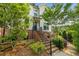 Charming two-story townhome with brick accents, landscaped yard, and inviting staircase leading to the entrance at 219 Phillips Ln, Alpharetta, GA 30009
