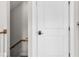 Hallway with stair access, door, and neutral paint at 219 Phillips Ln, Alpharetta, GA 30009