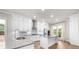 The kitchen is equipped with white cabinetry, a stainless steel range hood, and a center island at 219 Phillips Ln, Alpharetta, GA 30009