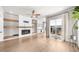 Bright living room features a modern fireplace, wooden shelves, and hardwood floors with a large sliding glass door at 219 Phillips Ln, Alpharetta, GA 30009